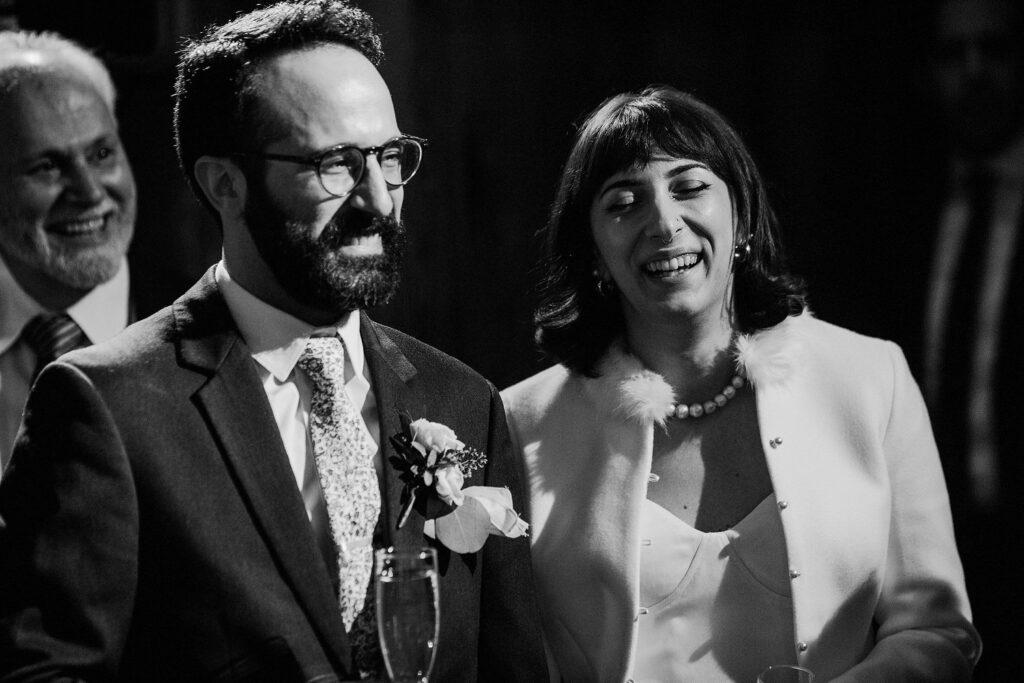 black and white photo of bride and groom's reactions