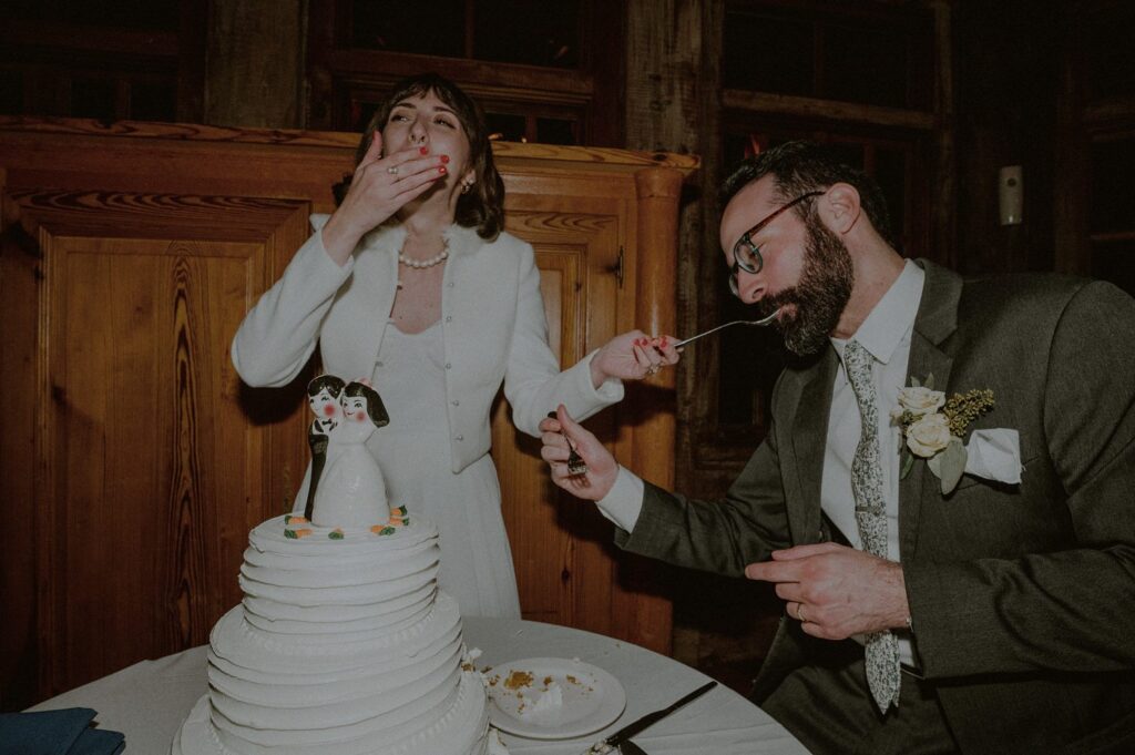 bride and groom being silly as they cut their wedding cake