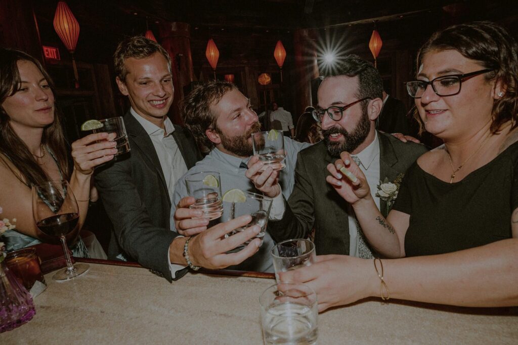 groom doing shots of tequila at bar with friends