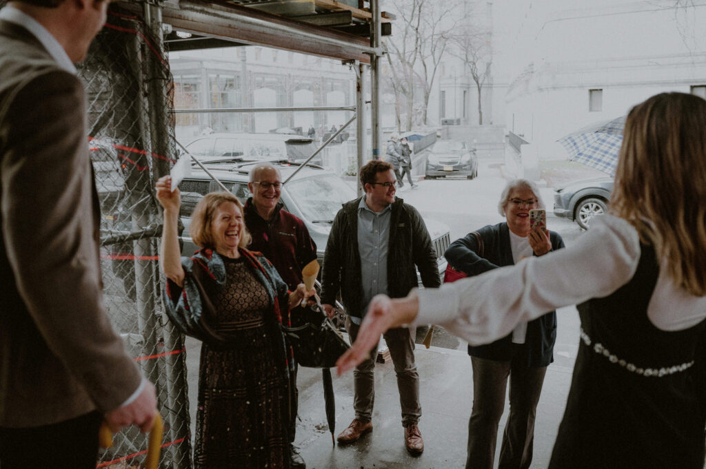 family waits outside of nyc city hall and throws flower seeds at couple who eloped