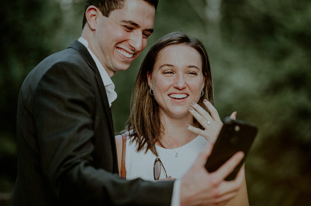 couple joyfully sharing news on a facetime phone call and woman showing off ring
