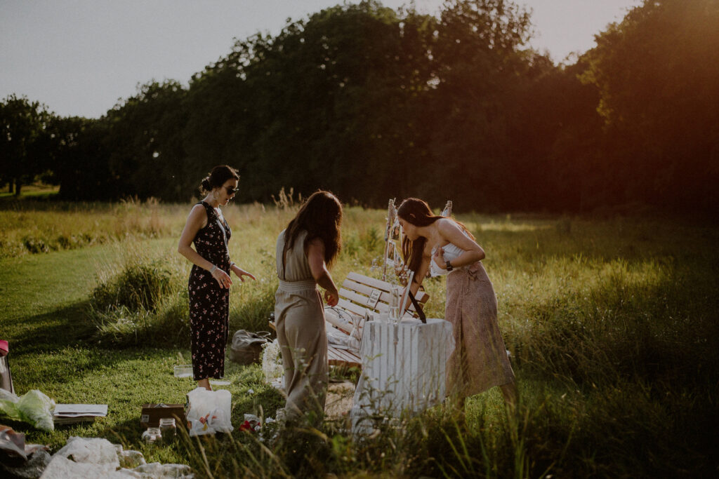 a group of ladies decorating a bench for a surprise wedding proposal