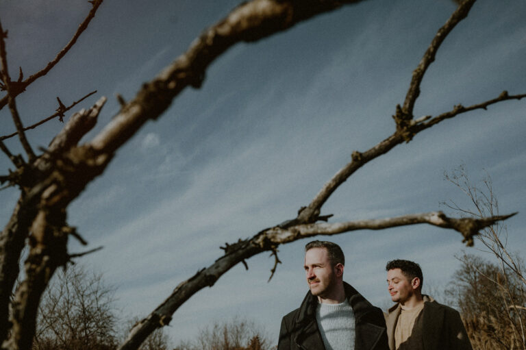 creative photo of same sex couple looking off in nj engagement session
