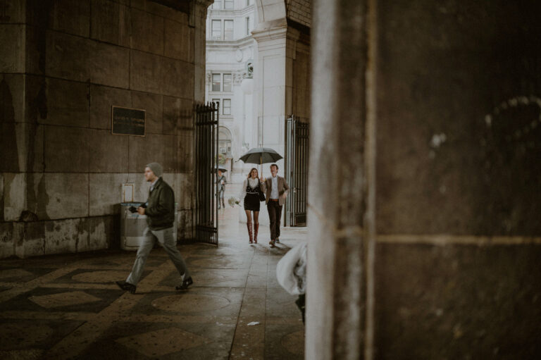 couple walking towards city hall elopement in rain