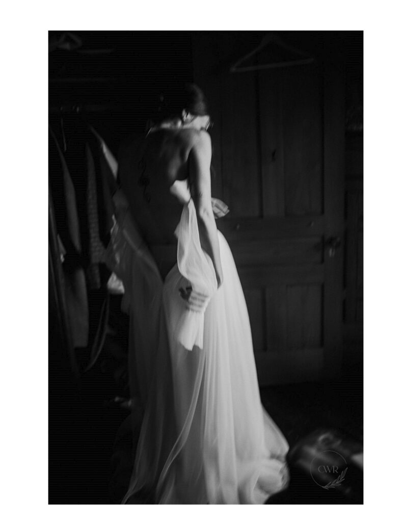 Artistic Black And White Photo Bride Getting Into Wedding Gown