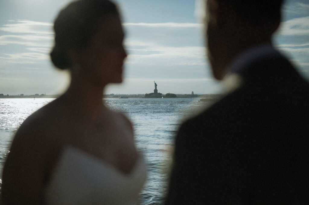 Artistic Photo Bride Groom Foreground Blurry Statue Of Liberty Background Nyc