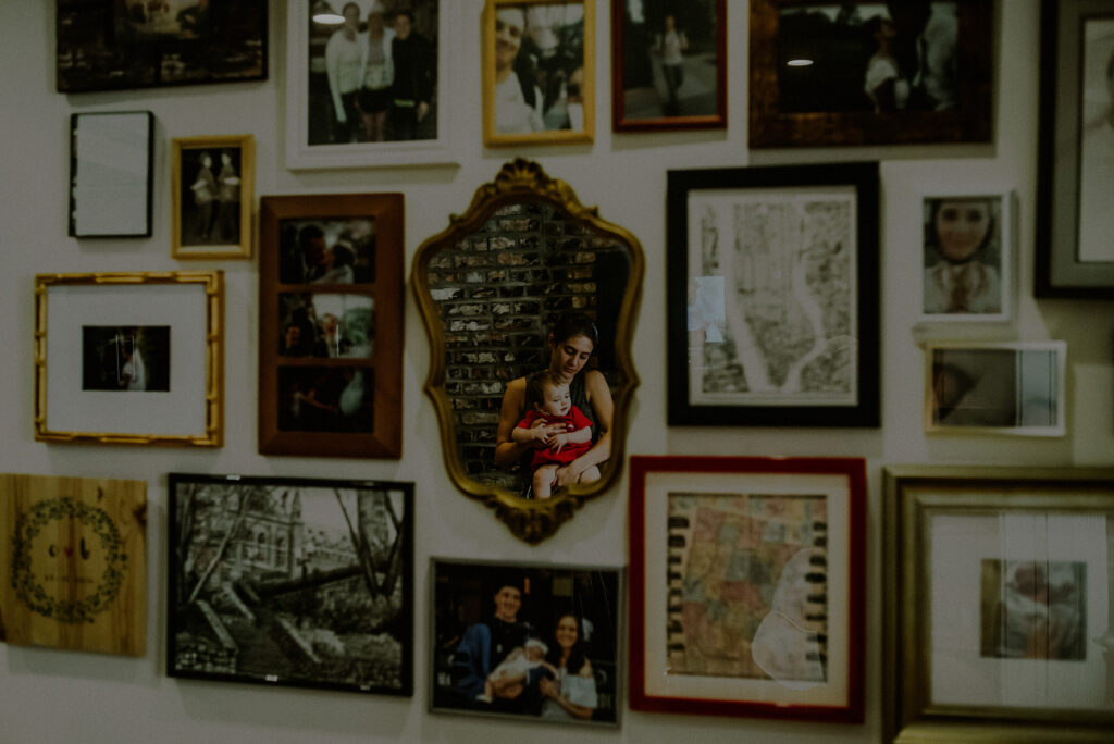 Artistic Photo Capturing Mom And Baby Amidst Family Frames