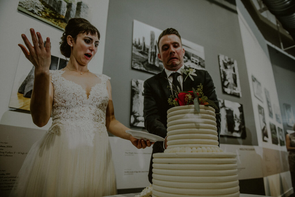 Bride Groom Funny Quirky Expression While Cutting Wedding Cake At Grounds For Sculpture