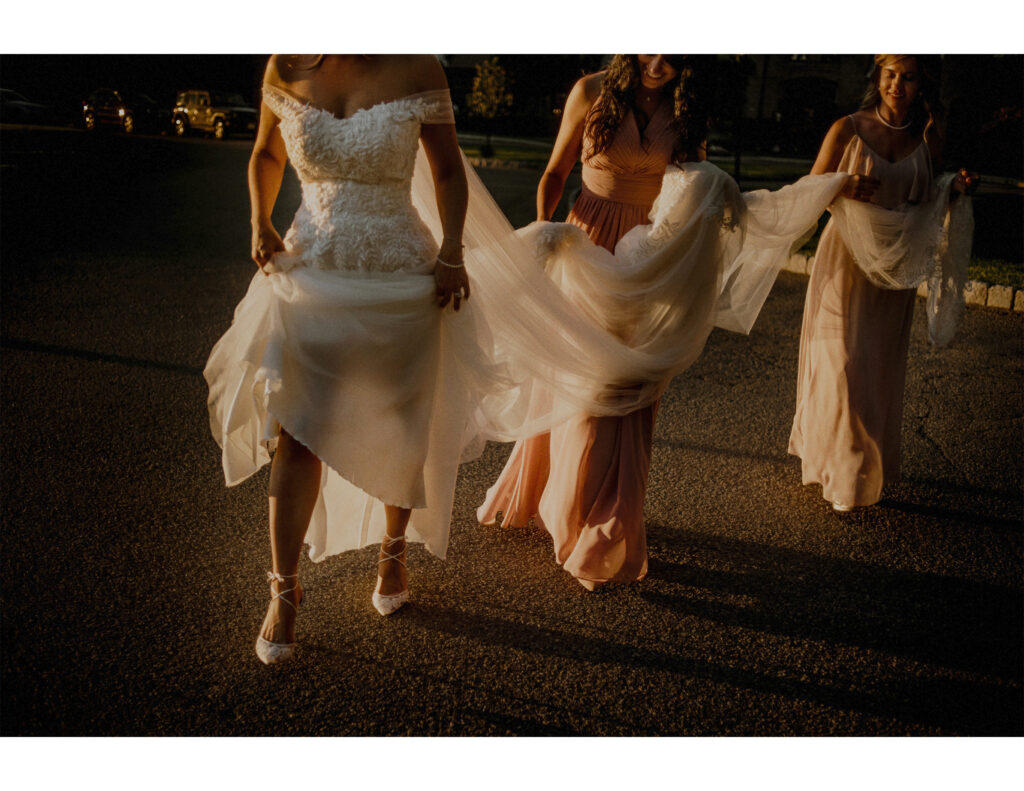 Bridesmaids In Sun Helping Bride