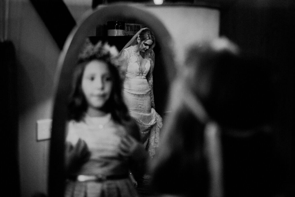 Child Looking In Mirror Bride In Background
