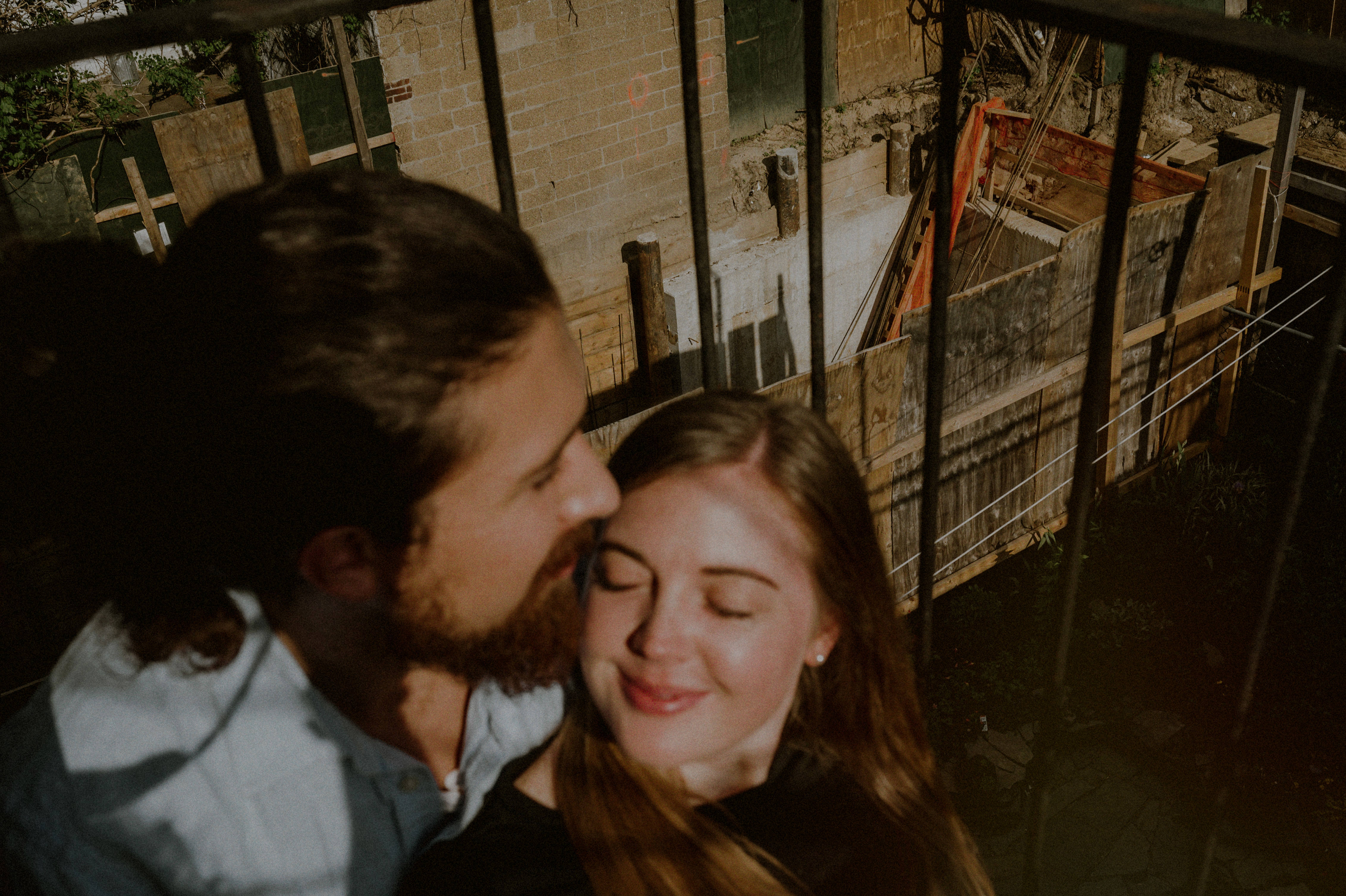 Couple Embracing Engagement Photo Urban Nyc Balcony