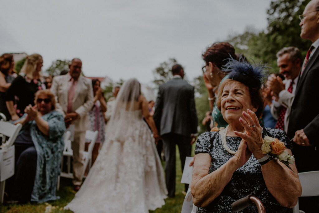 Grandmother Clapping As Bride Groom Exit Wedding Ceremony