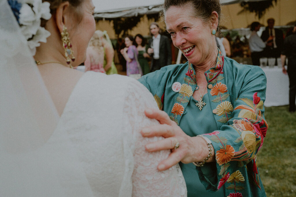 Wedding Guest Greeting Bride During Cocktail Hour Candid Moment