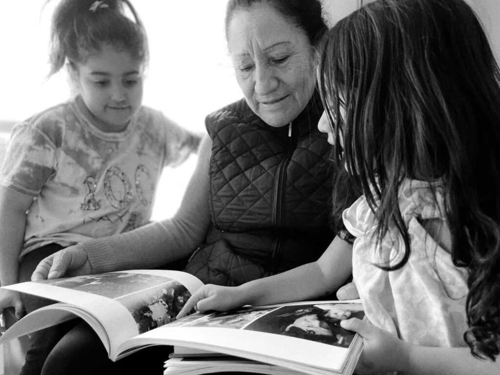 black and white photo of grandma reading with kids
