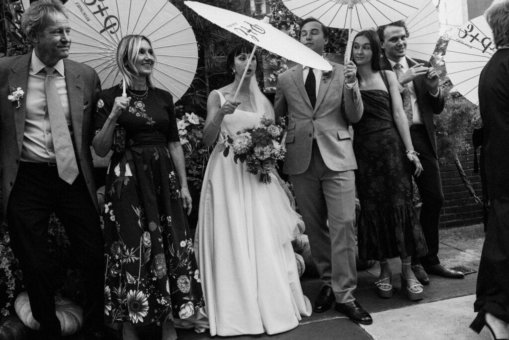 inbetween moment of family photo with parasls outside of restaurant in philadelphia